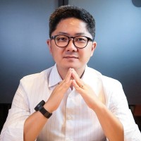 Foto do autor , etinia oriental de óculos com as mãos apoiadas no queixo